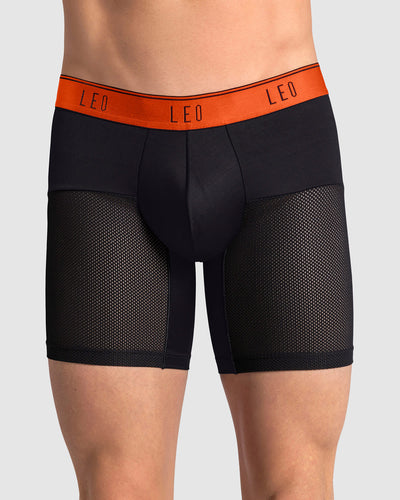 boxer-medio-de-secado-rapido-con-mallas-transpirables-en-microfibra#color_712-negro-con-elastico-naranja